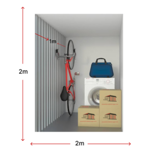 Interior view of a storage unit featuring a bicycle, washing machine, and stacked boxes.
