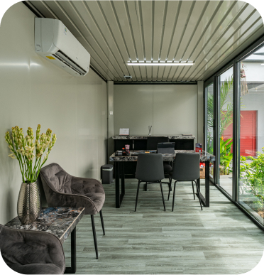 Interior view of a modern office space featuring glass walls and contemporary furniture.