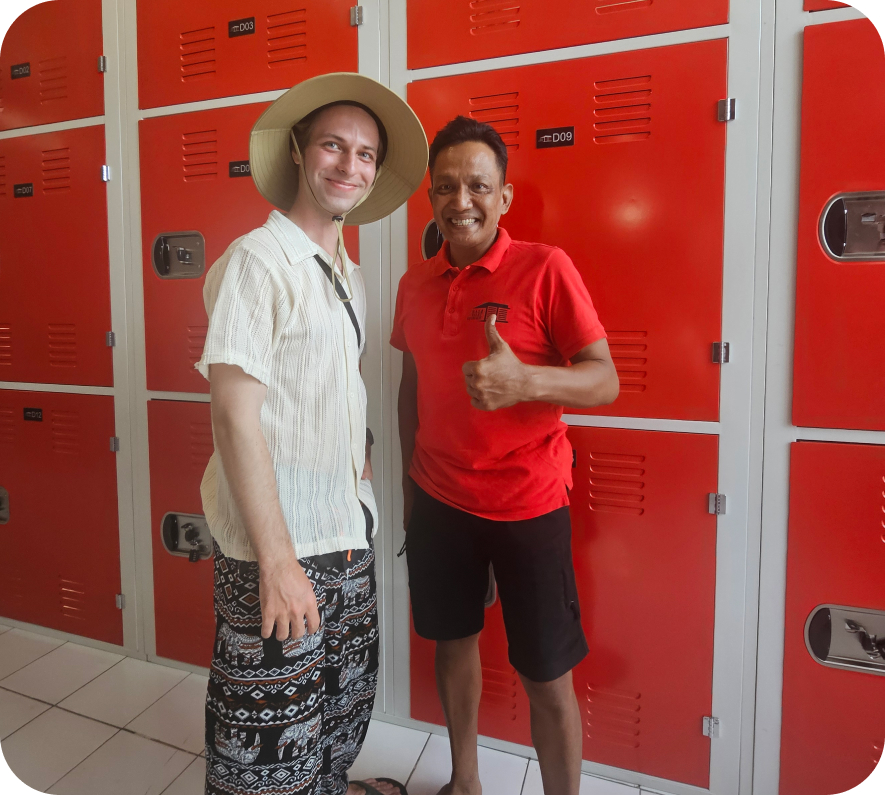 customer and bali valet employee posing for a picture in front of lockers