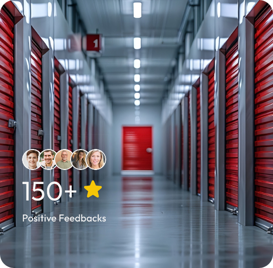 Interior view of a storage unit facility featuring red doors along a hallway.