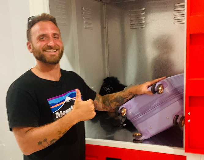 client posing for a photo in front of small storage unit