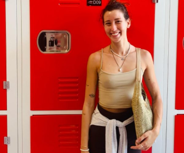 customer posing in front of a storage unit